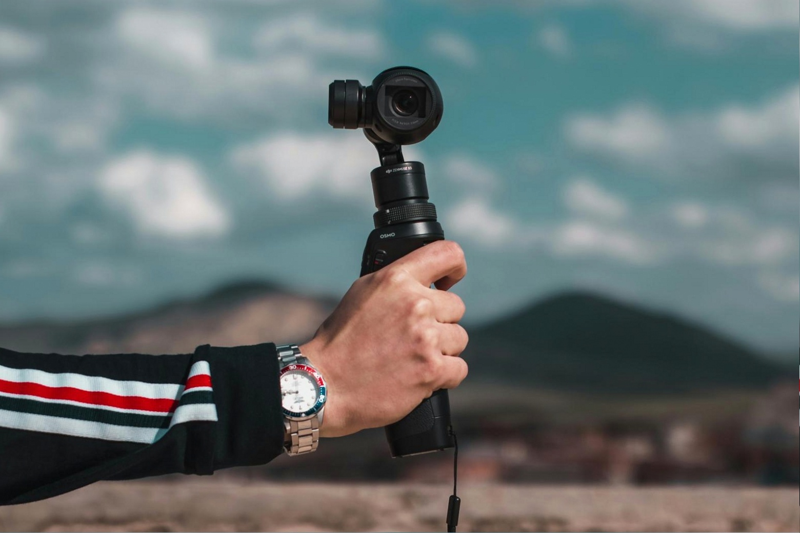 Close-up of a photographer setting up a reflector to redirect natural light onto a subject outdoors